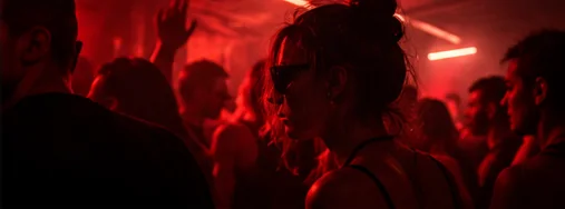 Dancers close together in deep red light